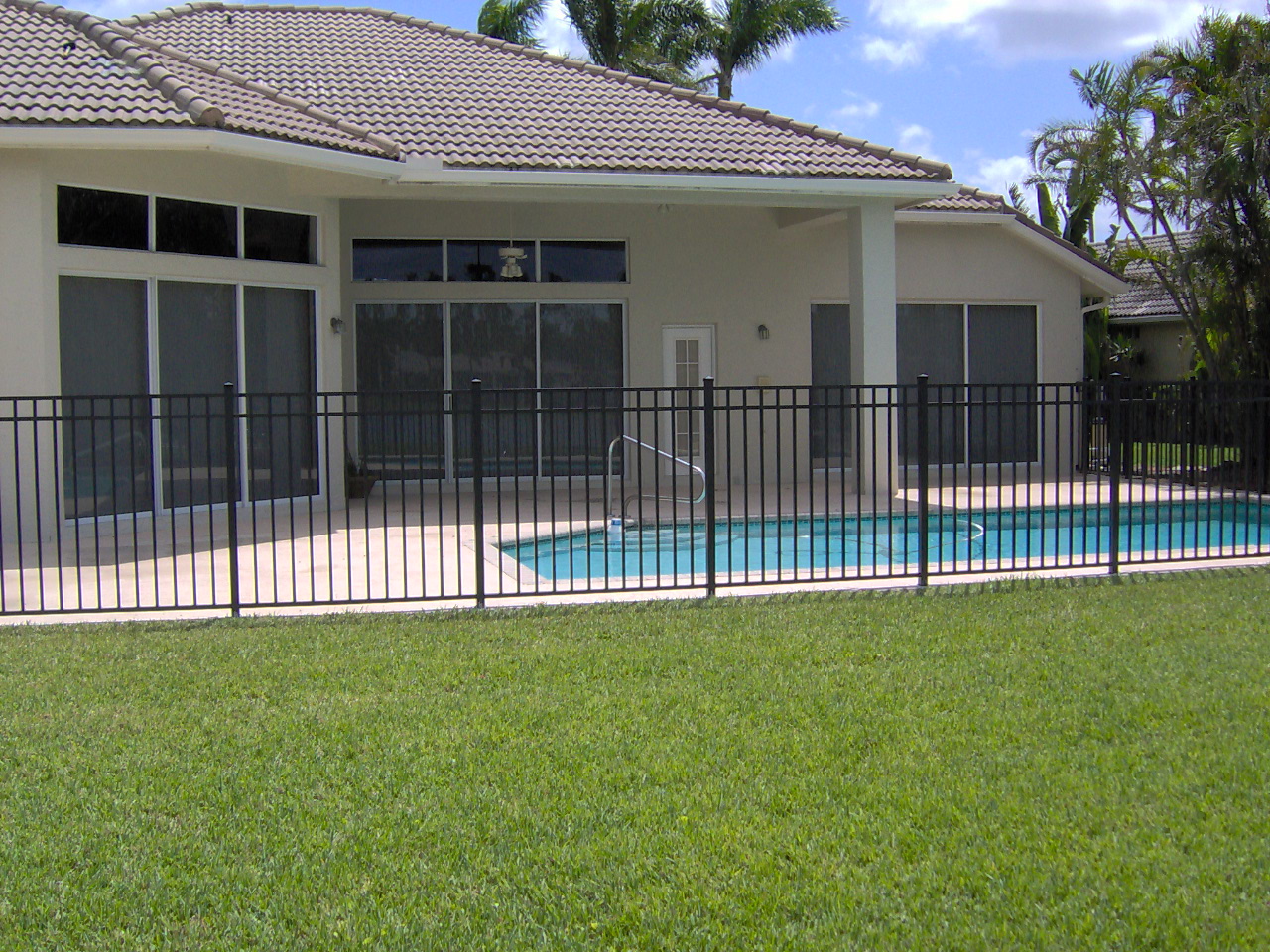 Black ornamental aluminum pool fence installed by Rapid Fence at a Palm Beach County home