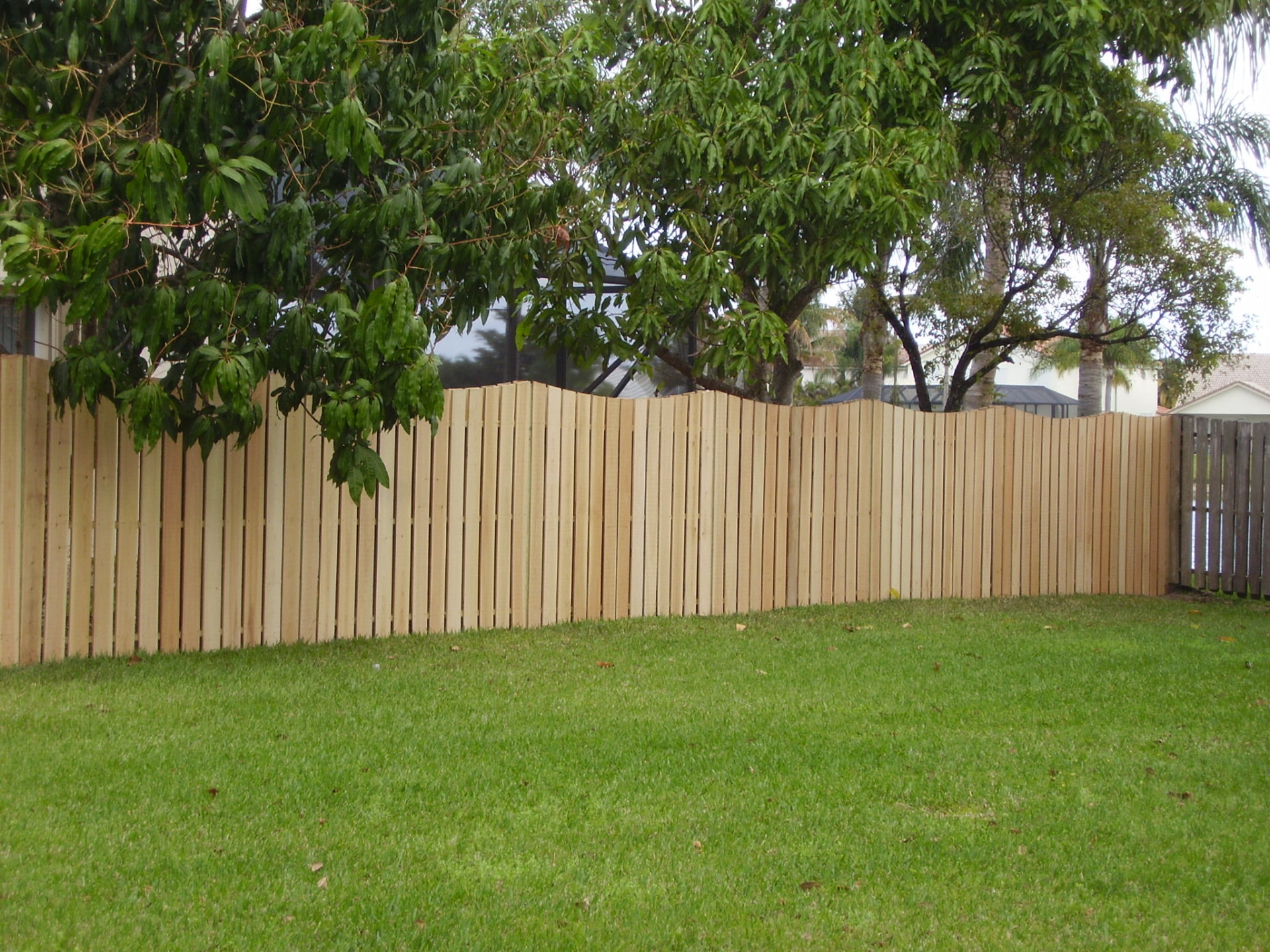 Wood shadowbox privacy fence along a residential back yard